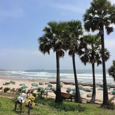Scenic view of Mutyalammapalem Beach with fishing boats and Syamala Konda hills near Vizag