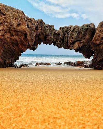 Natural rock arch and scenic coastline at Mangamaripeta Beach near Vizag