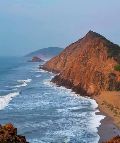 Scenic view of Gangavaram Beach with palm trees and coastline near Vizag Steel Plant